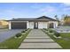Attractive home with desert landscaping, a modern garage door, and inviting curb appeal at 8409 E Clarendon Ave, Scottsdale, AZ 85251