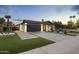 Charming home with a landscaped front yard, modern garage door, and desert accents at 8409 E Clarendon Ave, Scottsdale, AZ 85251