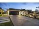 Beautifully landscaped home featuring a modern black garage door and inviting walkway with desert landscaping at 8409 E Clarendon Ave, Scottsdale, AZ 85251
