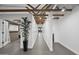 Open hallway features exposed beams, white walls, and tiled floors, creating a bright and airy atmosphere at 8409 E Clarendon Ave, Scottsdale, AZ 85251