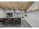 Modern kitchen boasts a large island with seating, stainless steel appliances, and stylish countertops and backsplash at 8409 E Clarendon Ave, Scottsdale, AZ 85251