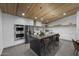 Modern kitchen boasts stainless appliances, sleek countertops, and a large island perfect for gathering and entertaining at 8409 E Clarendon Ave, Scottsdale, AZ 85251