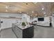 Spacious open kitchen features an eat-in island and seamlessly connects to the living and dining areas at 8409 E Clarendon Ave, Scottsdale, AZ 85251