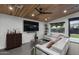 Modern living room with sleek gray tile, a wood slat ceiling and an oversized sectional sofa at 8409 E Clarendon Ave, Scottsdale, AZ 85251