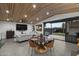 Modern, open concept living and dining area with access to the backyard patio at 8409 E Clarendon Ave, Scottsdale, AZ 85251