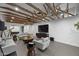 Stylish living room featuring exposed beams, contemporary furniture, large TV, and open design perfect for entertaining guests at 8409 E Clarendon Ave, Scottsdale, AZ 85251