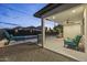 Covered patio with stylish furniture overlooks a pool, perfect for relaxation at 8409 E Clarendon Ave, Scottsdale, AZ 85251