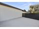 Side yard featuring a concrete pad, providing a simple and functional outdoor space at 8409 E Clarendon Ave, Scottsdale, AZ 85251