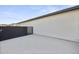 Concrete side yard enclosed by a black block wall and fence, enhancing privacy at 8409 E Clarendon Ave, Scottsdale, AZ 85251