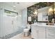 Modern bathroom with a glass-enclosed shower, floral wallpaper, and a bright vanity at 9331 S Lakeshore Dr, Tempe, AZ 85284