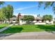 Beautiful home showcasing a lush lawn, mature landscaping, and a welcoming front porch at 9331 S Lakeshore Dr, Tempe, AZ 85284