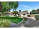 Charming single-story home with manicured lawn, mature trees, and a circular driveway at 9331 S Lakeshore Dr, Tempe, AZ 85284