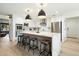 Modern kitchen with a large island, stainless steel appliances, pendant lighting, and seating for four at 9331 S Lakeshore Dr, Tempe, AZ 85284