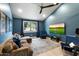 Cozy living room with a large sectional, a unique ceiling fan, a wall-mounted TV, and ample natural light at 9331 S Lakeshore Dr, Tempe, AZ 85284