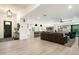 Spacious open floorplan with modern kitchen, dining area, and living room featuring light wood floors and stylish decor at 9331 S Lakeshore Dr, Tempe, AZ 85284