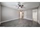 Bedroom featuring neutral walls, a modern ceiling fan, and convenient access to the laundry room and bathroom at 10411 N 11Th Ave # 28, Phoenix, AZ 85021