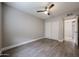 Neutral bedroom featuring wood look tile flooring, ceiling fan and closet at 10411 N 11Th Ave # 28, Phoenix, AZ 85021