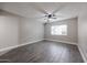 Bright bedroom with ceiling fan, complemented by neutral paint and enhanced by wood-look tile flooring at 10411 N 11Th Ave # 28, Phoenix, AZ 85021