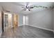 Spacious bedroom featuring an open closet and neutral walls, complemented by modern ceiling fan and wood-look tile flooring at 10411 N 11Th Ave # 28, Phoenix, AZ 85021