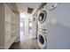 Hallway showcasing storage shelves and conveniently located washer/dryer, complemented by neutral walls and continuous wood-look flooring at 10411 N 11Th Ave # 28, Phoenix, AZ 85021