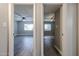 Open hallway view into rooms featuring modern ceiling fans, neutral walls, and wood-look tile flooring at 10411 N 11Th Ave # 28, Phoenix, AZ 85021