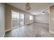 Bright living room with sliding doors and neutral paint, enhanced by modern lighting and durable, stylish gray flooring at 10411 N 11Th Ave # 28, Phoenix, AZ 85021