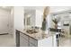 This kitchen island boasts a stainless steel sink with double basins set in a granite countertop with modern fixtures at 10616 W Sonrisas St, Tolleson, AZ 85353