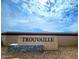 Community entrance sign, 'Trouvaille', set against a clear sky, showcasing the neighborhood's identity at 10616 W Sonrisas St, Tolleson, AZ 85353