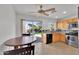 Cozy kitchen area with wood cabinets and sliding glass door to outdoor patio seating at 10656 E Plata Ave, Mesa, AZ 85212