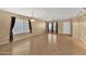 Spacious living room featuring tile floors, contemporary lighting, and neutral decor at 10656 E Plata Ave, Mesa, AZ 85212