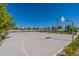 Community basketball court featuring manicured landscaping, lighting, and seating areas for spectators at 11051 E Ulysses Ave, Mesa, AZ 85212