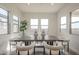 Bright dining room featuring a modern table, stylish chairs, and large windows at 11051 E Ulysses Ave, Mesa, AZ 85212