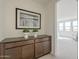 Stylish hallway with a dark wood cabinet and view into the bedroom at 11051 E Ulysses Ave, Mesa, AZ 85212