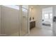 Modern bathroom featuring a glass shower, double vanity, and neutral tiling at 11051 E Ulysses Ave, Mesa, AZ 85212