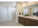 Main bathroom featuring a double vanity, glass shower, and modern fixtures at 11051 E Ulysses Ave, Mesa, AZ 85212