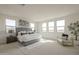 Bright main bedroom with large windows, tufted headboard, and decorative art at 11051 E Ulysses Ave, Mesa, AZ 85212