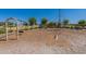 Community playground featuring a swing set and a climbing structure on a wood chip surface at 11051 E Ulysses Ave, Mesa, AZ 85212