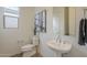 Chic powder room with pedestal sink, modern art, and ample natural light at 11051 E Ulysses Ave, Mesa, AZ 85212