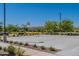 A basketball court is surrounded by lush landscaping and community seating and shade structures at 11107 E Ulysses Ave, Mesa, AZ 85212