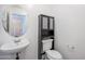 Powder room featuring a pedestal sink, storage cabinet and a toilet at 1202 W Central Ave, Coolidge, AZ 85128