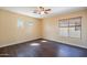 The bedroom has wood flooring and natural light from the windows at 1202 W Central Ave, Coolidge, AZ 85128