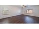 Empty bedroom with wood floors, baseboards, ceiling fan, and window with blinds at 1202 W Central Ave, Coolidge, AZ 85128