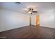 Spacious bedroom featuring wood-look floors, a ceiling fan, and an ensuite bathroom with a walk-in closet at 1202 W Central Ave, Coolidge, AZ 85128