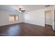 Empty bedroom with ceiling fan, wood-look floors, baseboards, and window at 1202 W Central Ave, Coolidge, AZ 85128