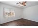 This bedroom features wood flooring and a window for natural light at 1202 W Central Ave, Coolidge, AZ 85128