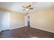 A modern bedroom with wood-look flooring, a ceiling fan, and neutral paint at 1202 W Central Ave, Coolidge, AZ 85128