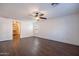 Large bedroom featuring wood-look floors, a ceiling fan, and a walk-in closet at 1202 W Central Ave, Coolidge, AZ 85128