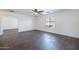 Bedroom featuring wood-look floors, a ceiling fan, and a large window at 1202 W Central Ave, Coolidge, AZ 85128