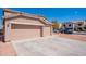 Three car garage and extended driveway offer generous parking and attractive desert landscaping at 1202 W Central Ave, Coolidge, AZ 85128