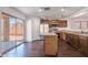 Bright kitchen with stainless steel appliances, wood cabinets, island, and sliding glass door to backyard at 1202 W Central Ave, Coolidge, AZ 85128